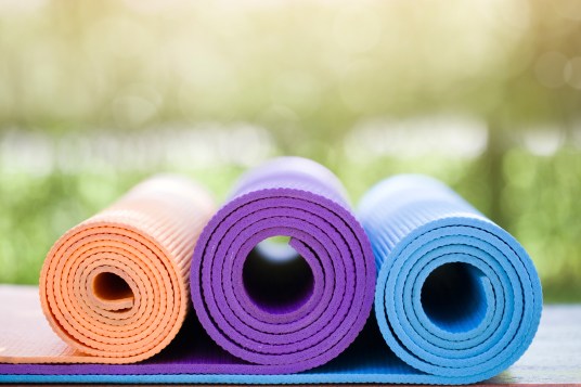 many yoga mats on the wood table in the garden